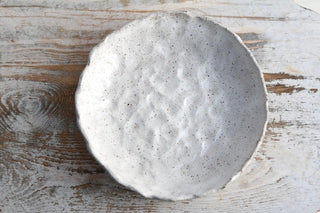 a white plate sitting on top of a wooden table