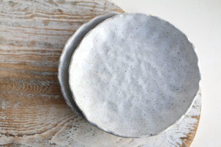 a white bowl sitting on top of a wooden table