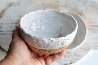 a person holding a bowl in their hand