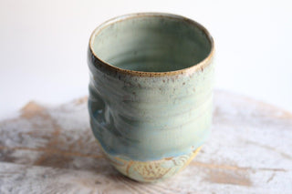 a ceramic cup sitting on top of a table