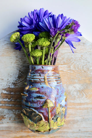 Handmade ceramic wall vase with gold accents and a moonlight forest design perfect for dried or fresh floral arrangements